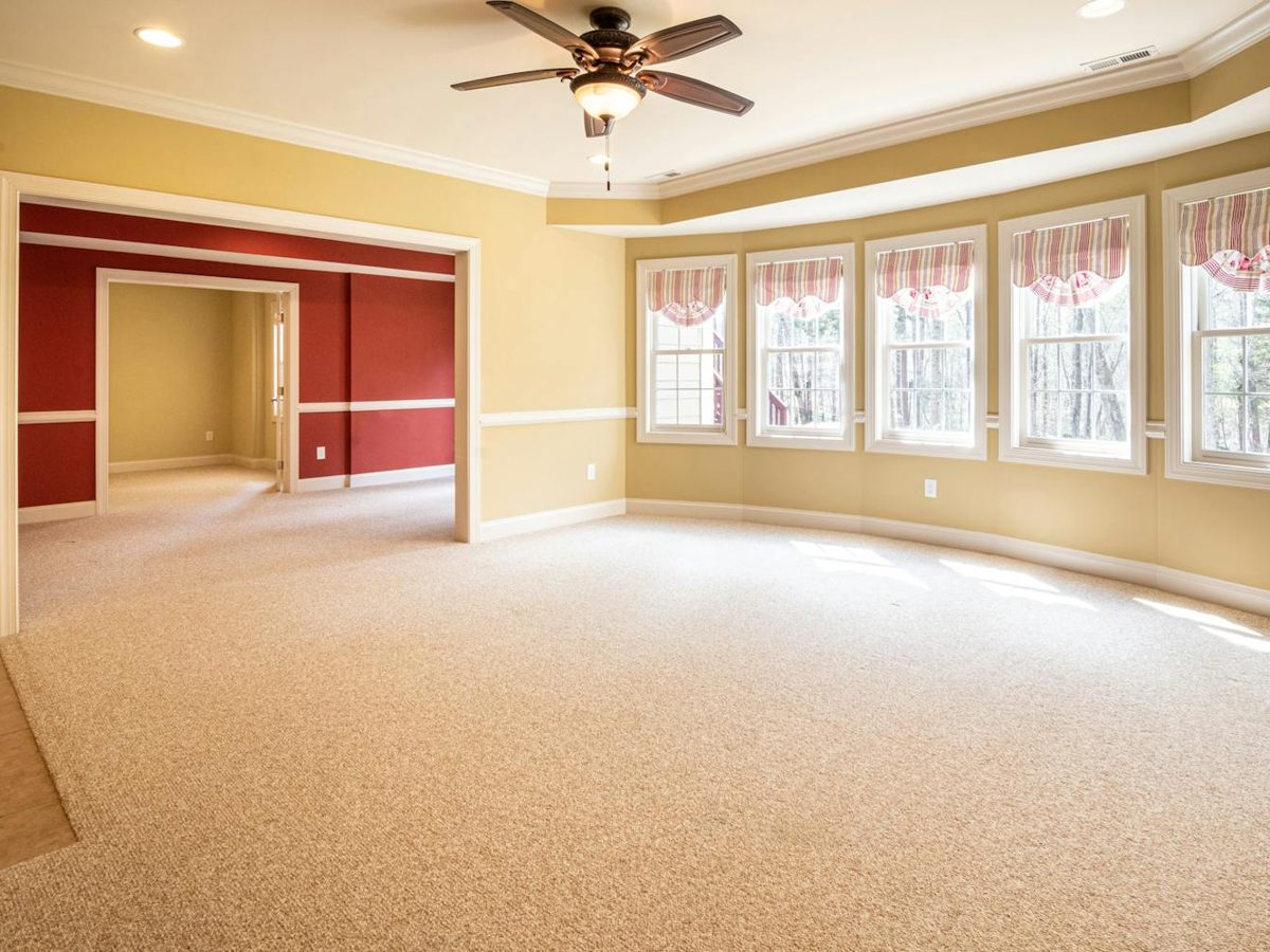 Carpet being deep-cleaned in an empty room ready for inspection