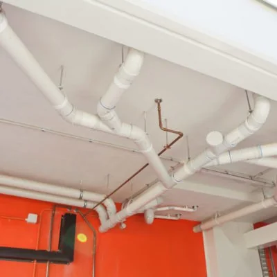 Commercial plumbing pipework with painted feature wall