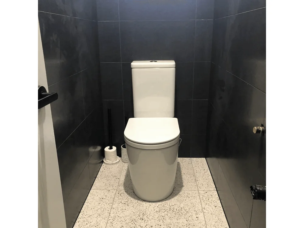 Completed bathroom renovation with terrazzo flooring