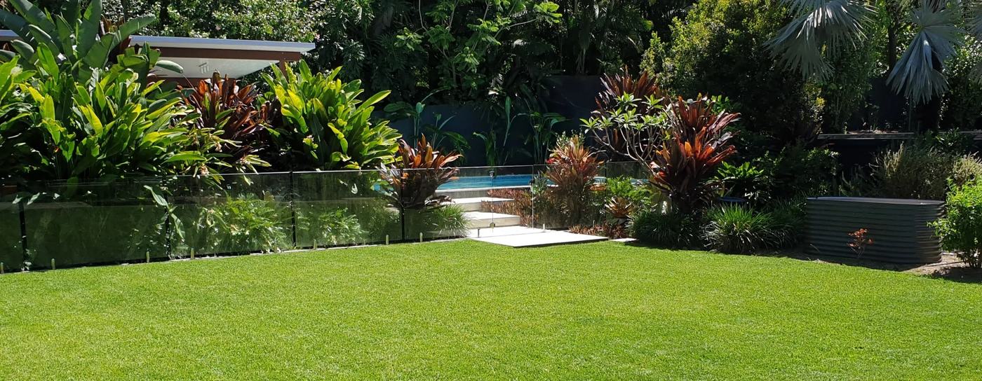 Beautifully maintained green lawn and tropical garden in Brisbane