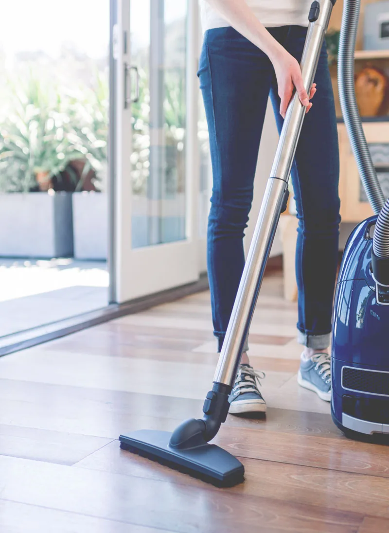 A professional cleaner working through a bright Noosa home