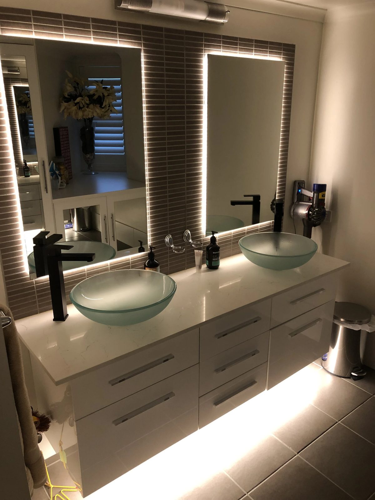 Backlit LED mirror and feature lighting in a renovated Brisbane bathroom