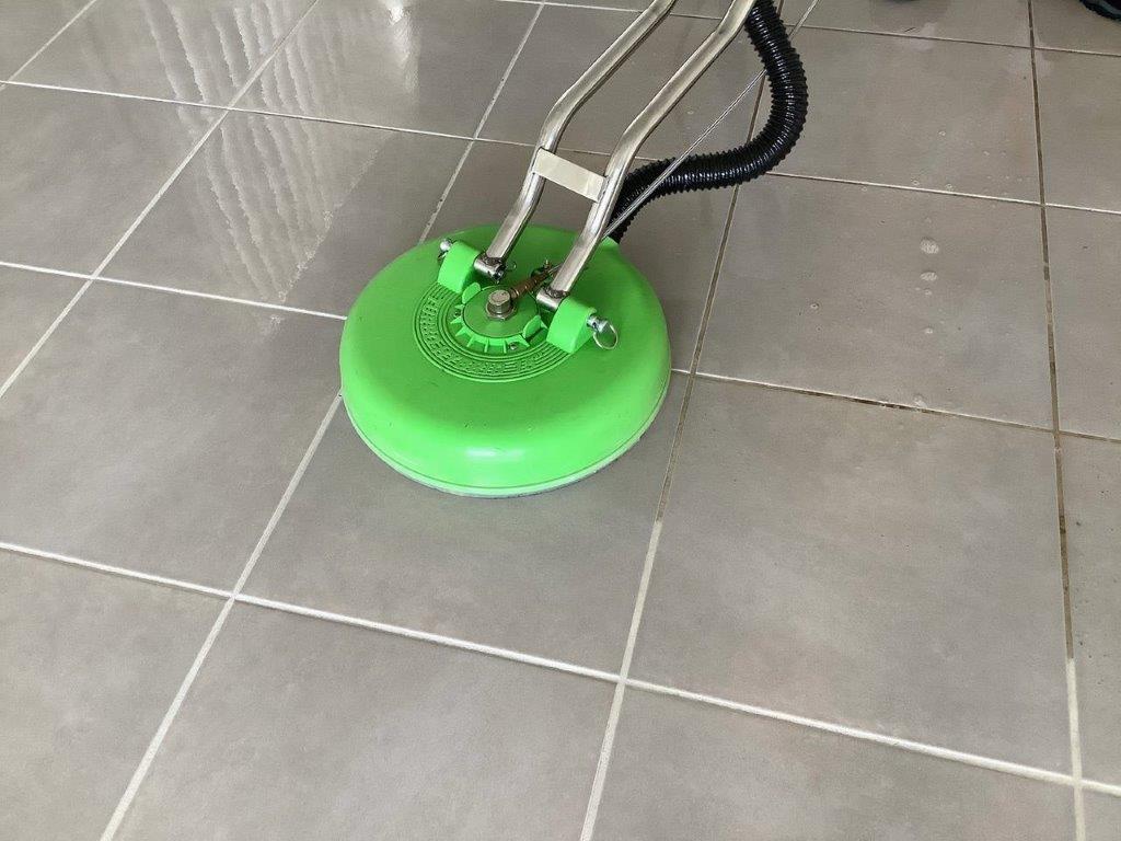 Dirty tiles being cleaned by machine