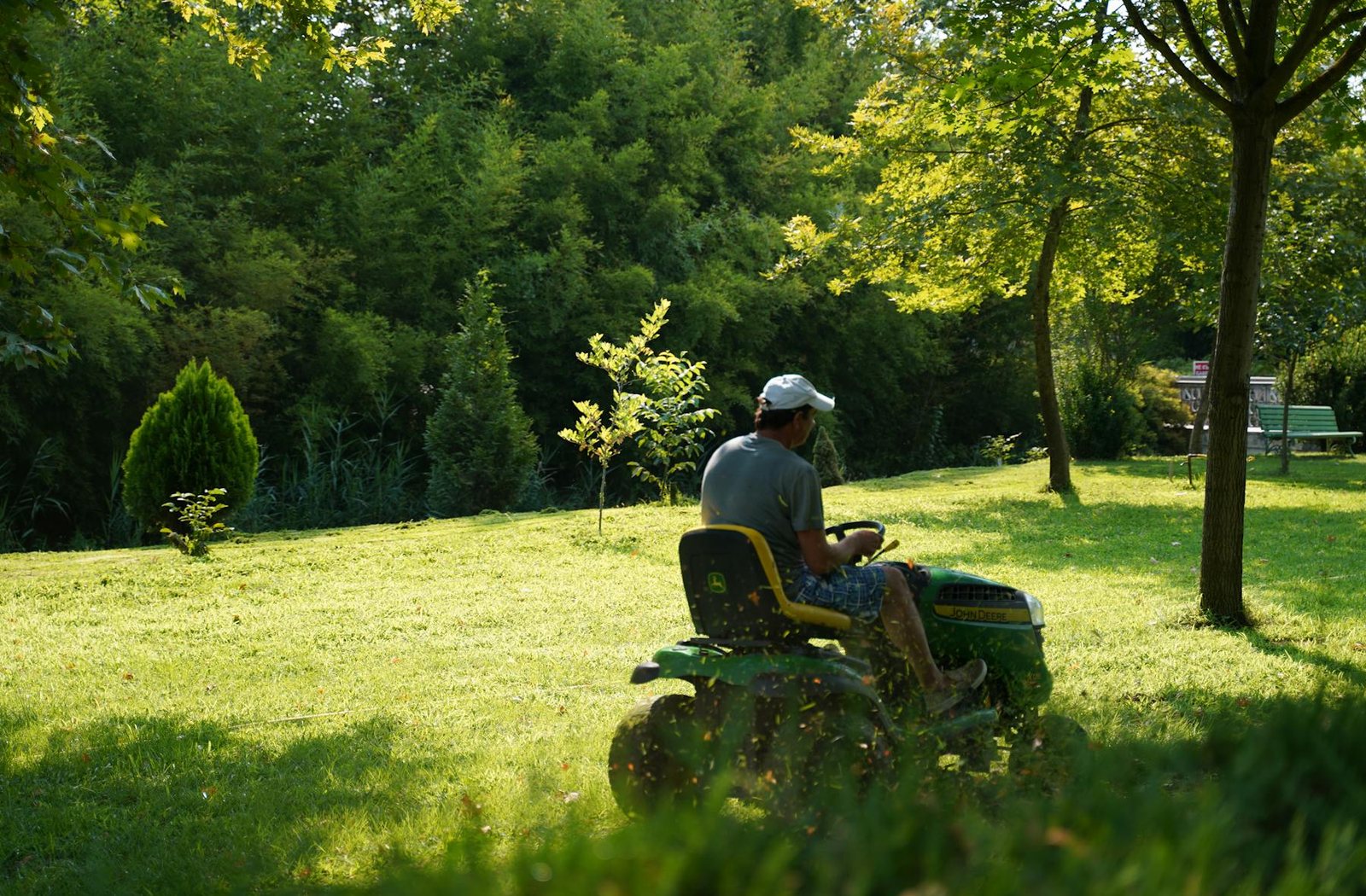 Lawn mower maintaining a green garden area