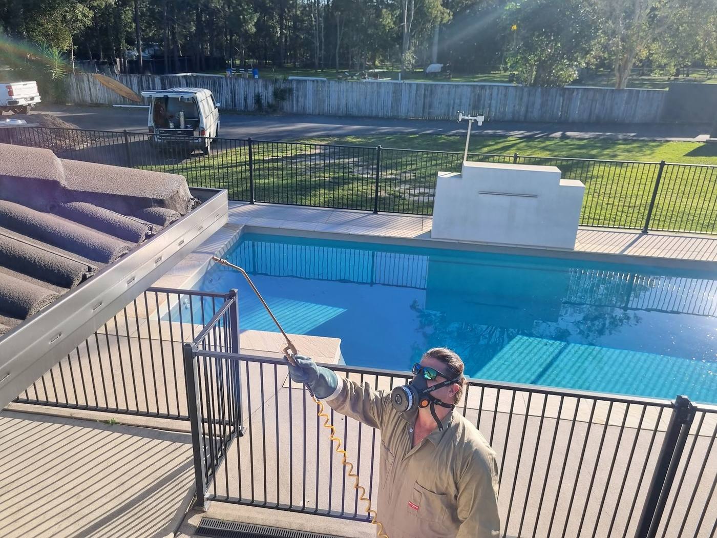 Ticked Off technician treating a Caboolture property near a swimming pool