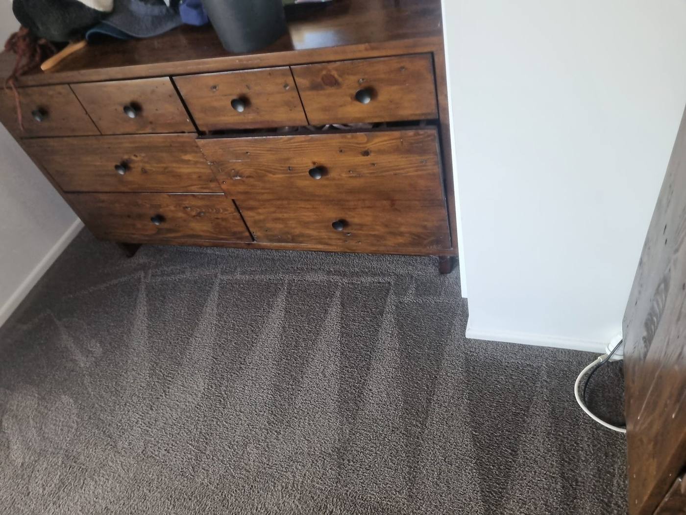 Bedroom carpet after professional cleaning with fresh vacuum lines