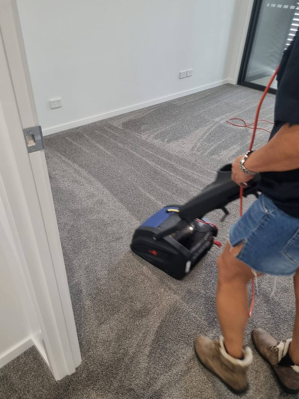 Carpet being deep cleaned with a professional machine