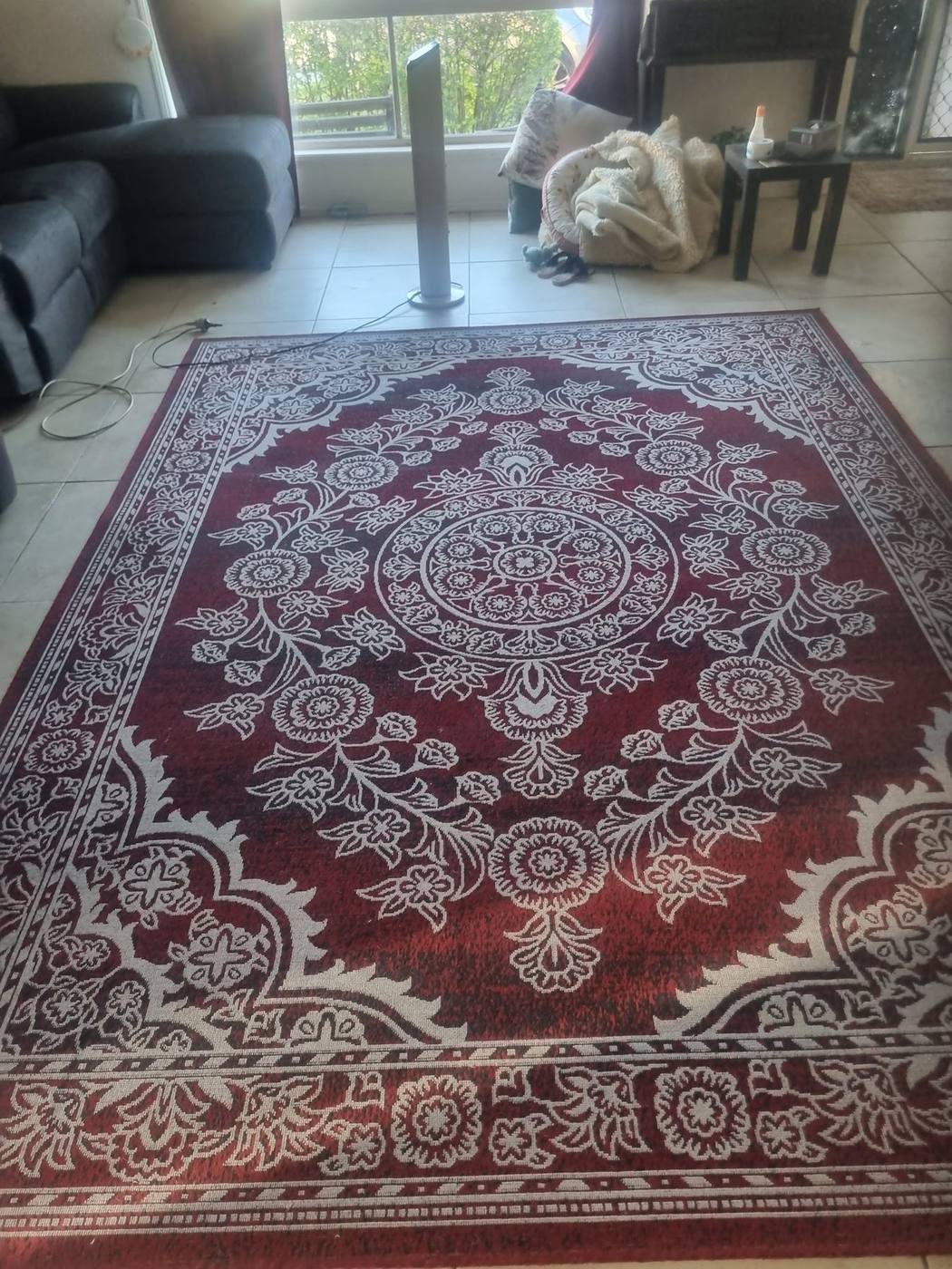 Ornate red rug cleaned and refreshed in a living room