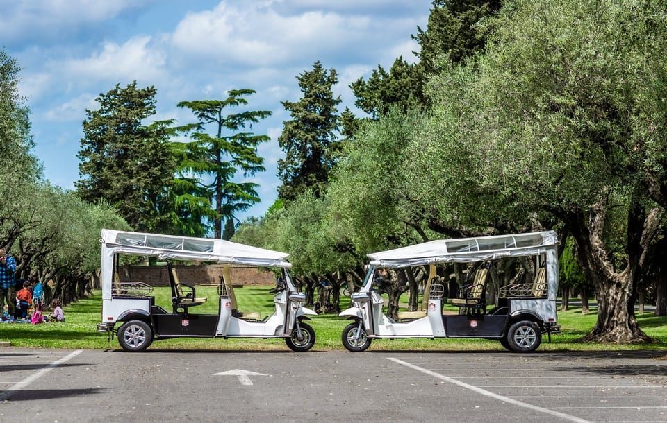 The electric tuk tuk fleet parked among trees
