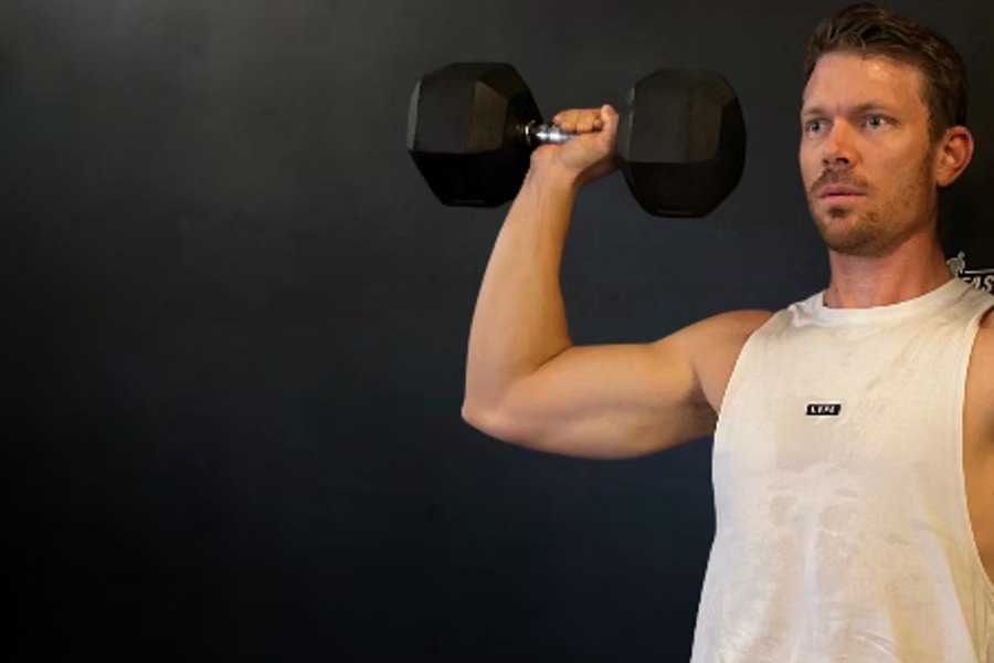 Man using dumbbells for a shoulder exercise